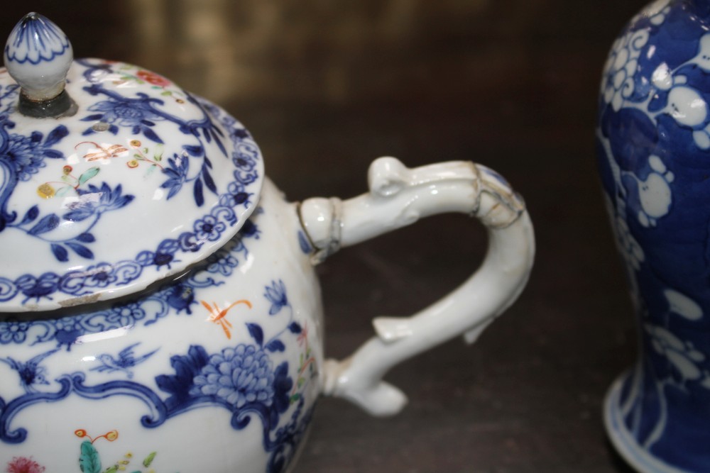 An 18th century Chinese export teapot and a pair of prunus pattern vases and covers